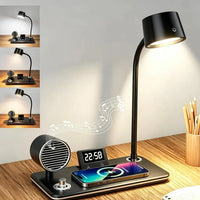 A black multi-functional desk lamp with an adjustable gooseneck head, a built-in USB charging port with a smartphone placed on it, a digital alarm clock, and a small round speaker on a wooden desk. The main lamp is illuminated, and three smaller inset images on the left show alternate angles or additional features.