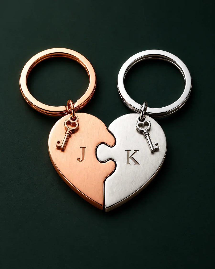 Two interlocking heart-shaped keychains in rose gold and silver with initials J and K.