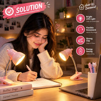 Clip-on LED reading light clamped onto a book highlighting text in a dark bedroom setting