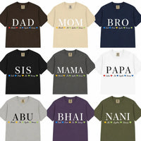 A 3x3 grid showing nine short-sleeve crew-neck T-shirts in different colors, each printed with a large family name (DAD, MOM, BRO, SIS, MAMA, PAPA, ABU, BHAI, NANI) and smaller text including 'Dad Mom Brother', 'Sister', 'Brother', 'Adele', 'Agynni', and 'Haruto'.