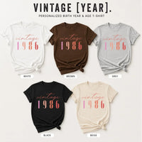 Six personalized birth year and age T-shirts in different colors are displayed on a light beige background with the text 'VINTAGE [YEAR).' at the top.