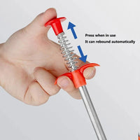 Hand holding a red and silver spring-loaded tool with text indicating its function.