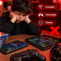 A young boy sits at a wooden desk with a PS4 controller, a tablet, and a phone showing game screens. Red graphic overlays highlight features like 'NO INTERNET', 'LIMITED GAMES', and 'BOREDOM' with a large red X, suggesting a gaming plan or subscription service.