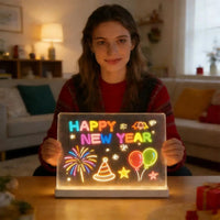 A woman holding a glowing rectangular LED light sign that says 'HAPPY NEW YEAR' with colorful neon-style illustrations including fireworks, balloons, stars, and a party hat, set in a warmly lit living room.