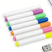 Six white USB refillable highlighters in assorted colors (purple, green, blue, orange, pink, yellow) arranged diagonally on a white background, with a silver USB connector visible in the bottom right corner.