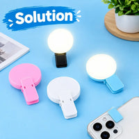 Rechargeable mini selfie ring light clipped securely onto the top edge of a mobile phone