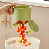 Close up view of the mechanical one click button releasing food waste from the bottom buckle gate.