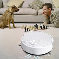 Robot vacuum cleaner on a carpeted floor with a man and dog in the background.