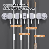 Wall-mounted multi-pipe holder with several vertical metal pipes secured in gray slots, shown on a dark gray background with text reading 'Compatible with different thicknesses' and size labels for the pipes.