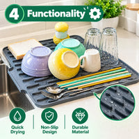 A dark gray silicone kitchen dish drying rack placed over a sink, shown with bowls, cups, chopsticks, spoons, and a slice of bread. The image includes marketing text and icons highlighting features like functionality, quick drying, non-slip design, and durable material, plus a circular inset showing water droplets on the rack.