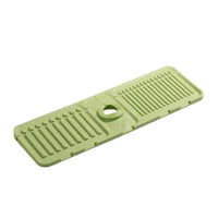 Green plastic mat with textured surface and central hole on a white background